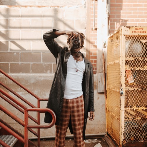 An image of a man with a camera taking a picture